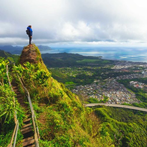 peron on top of mountain overlooking a town