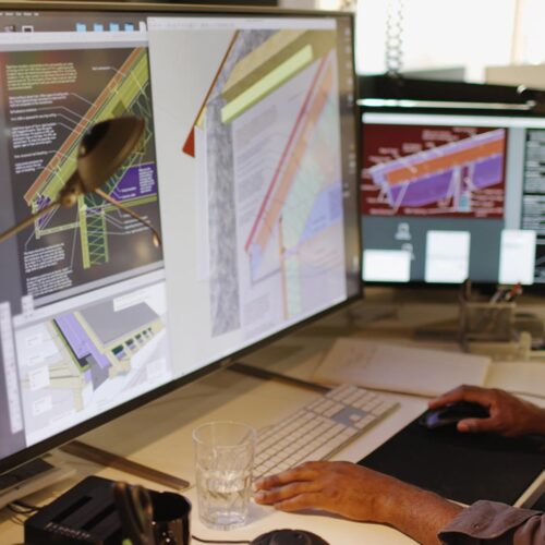 computer screen with man working on it